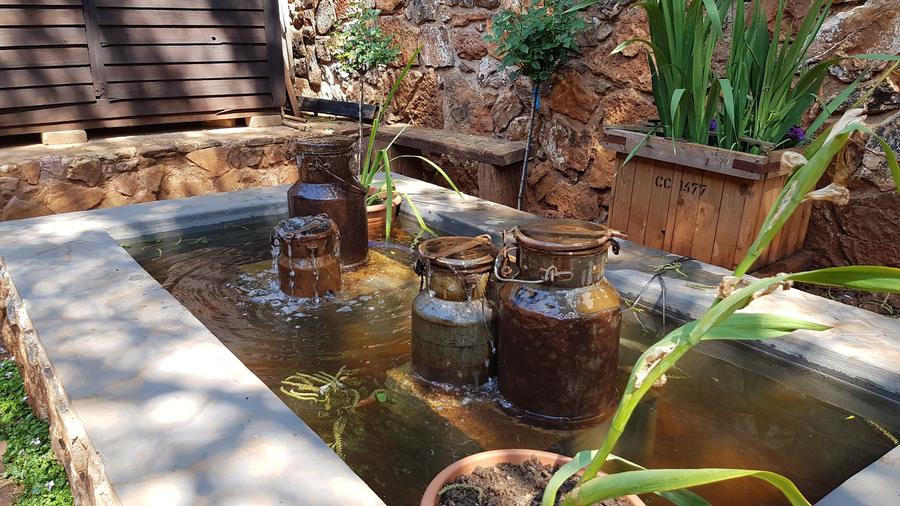 Recycled churn rill in stone courtyard